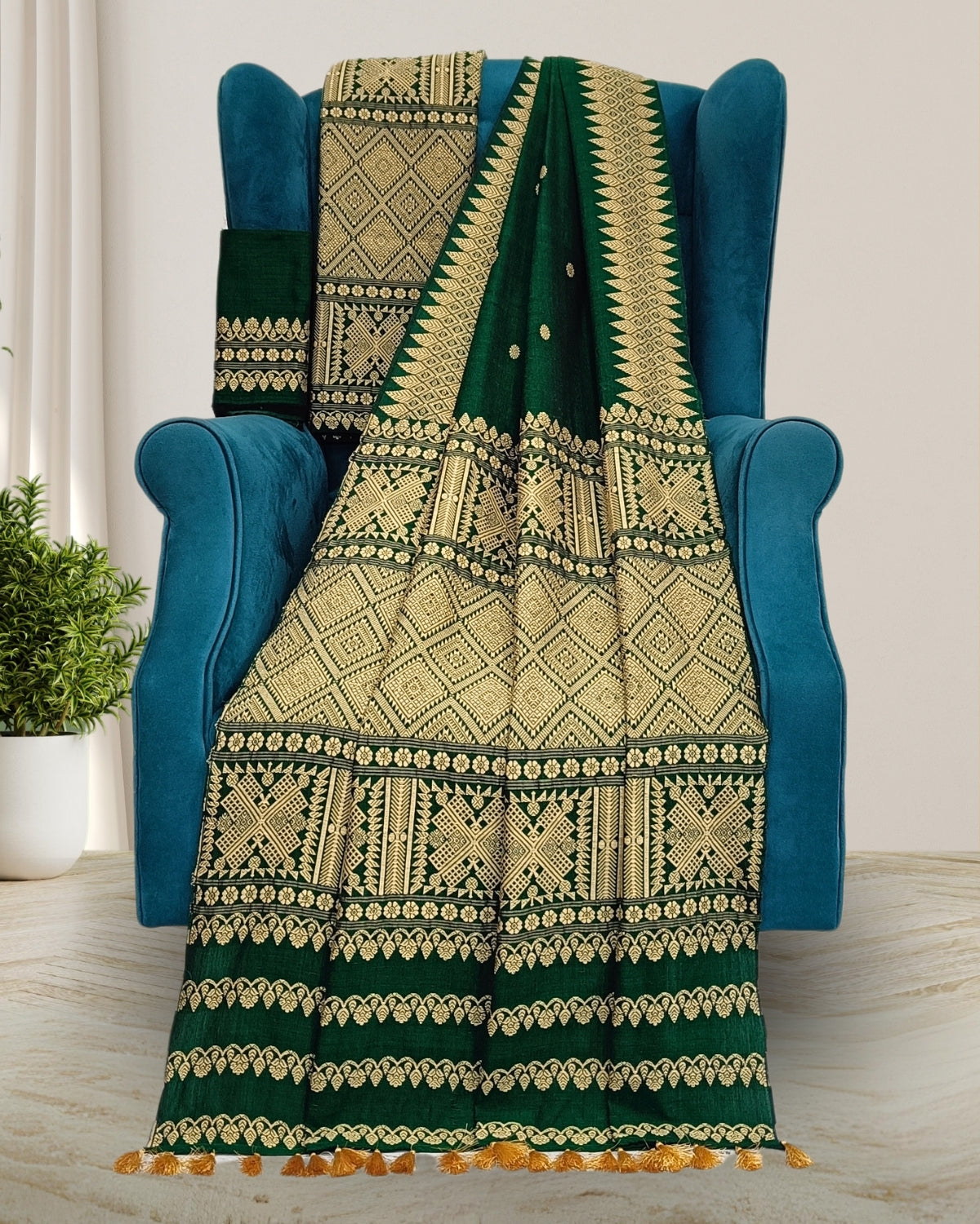 Woman wearing a green and gray patterned mekhela sador on a white background