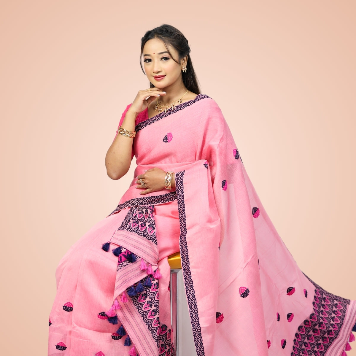 Women wearing pink Kesapaat cotton mekhela sador from Assam
