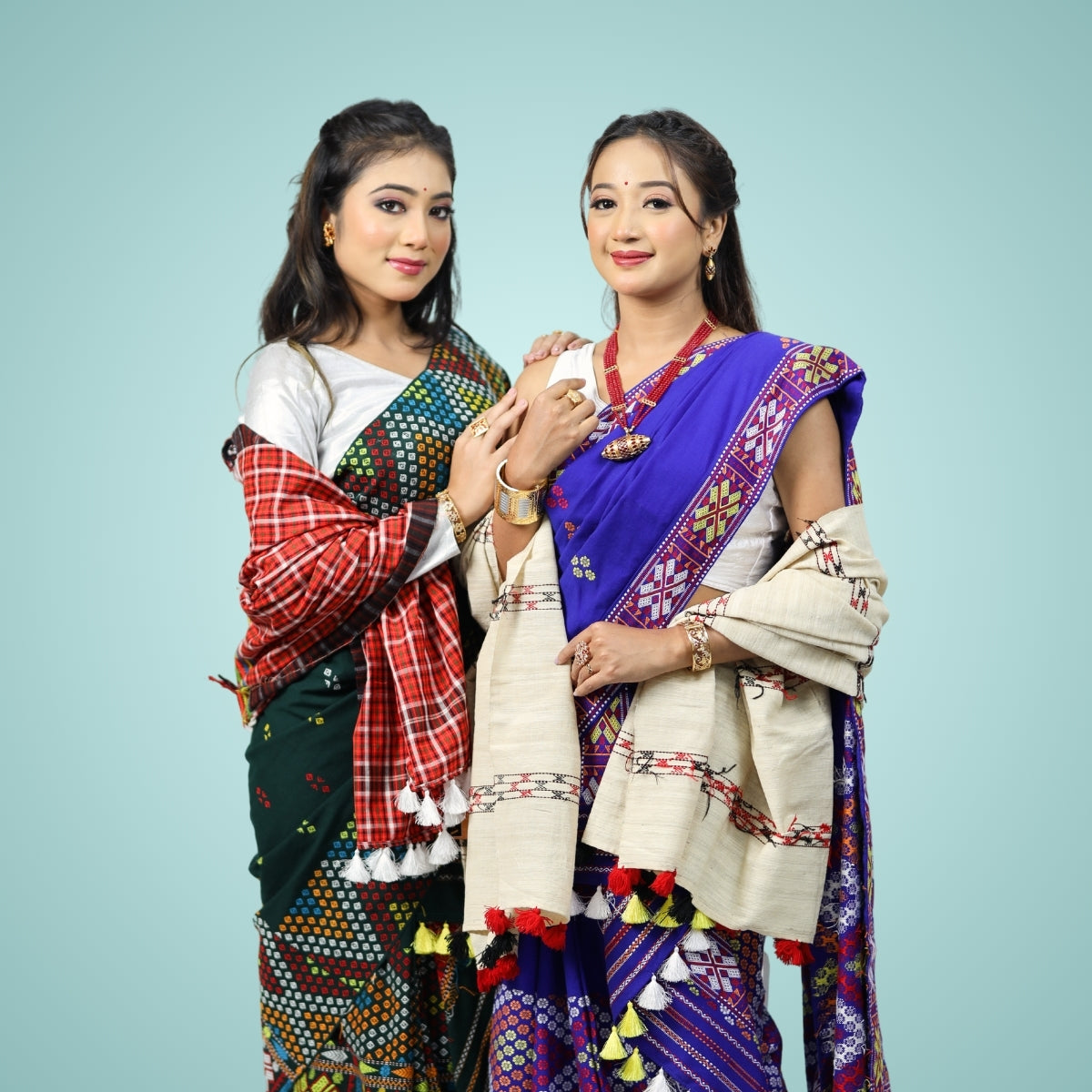 Women wearing traditional Mising design mekhela sador and shawls